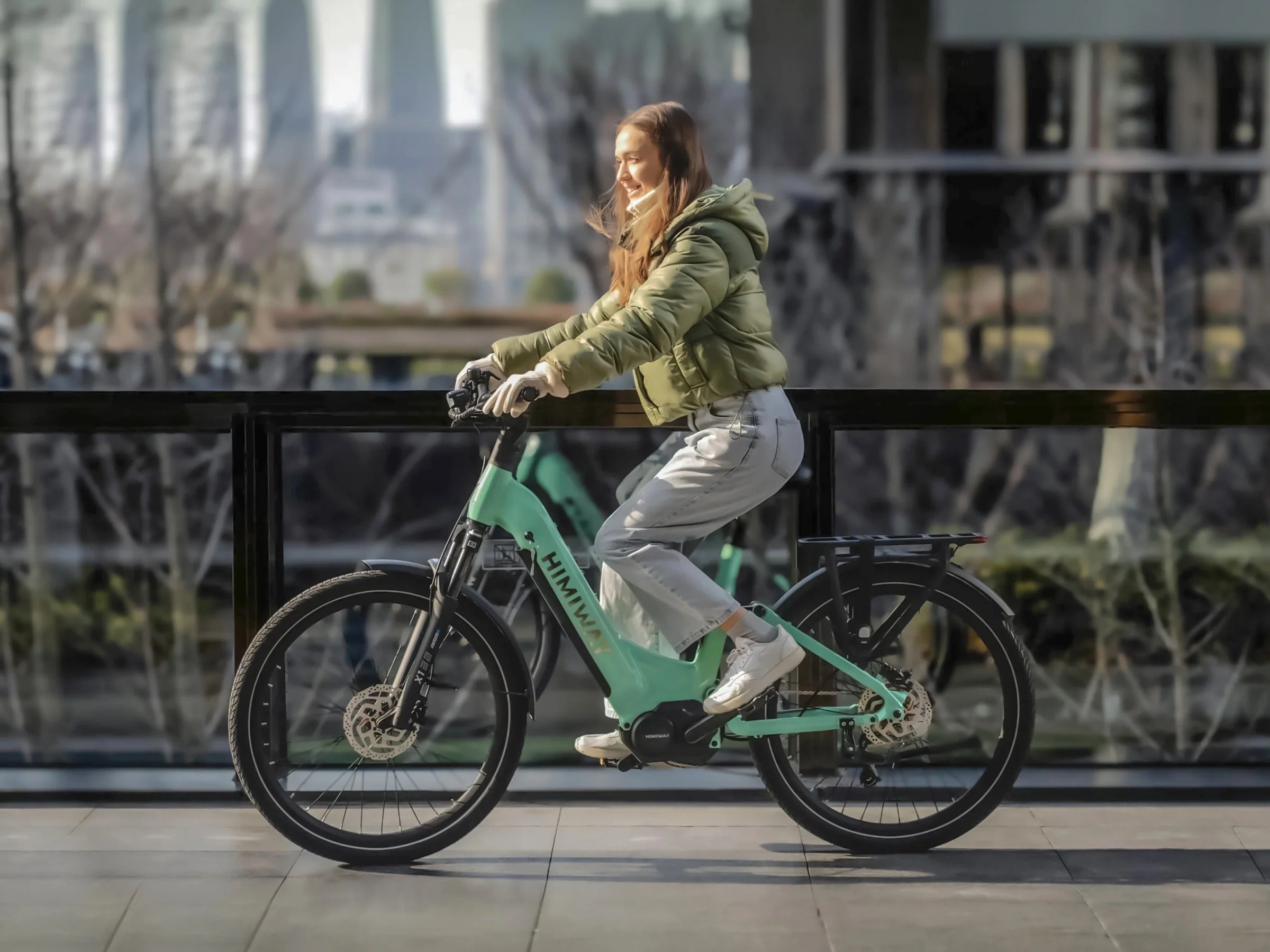 Person riding a green electric bike in an urban setting