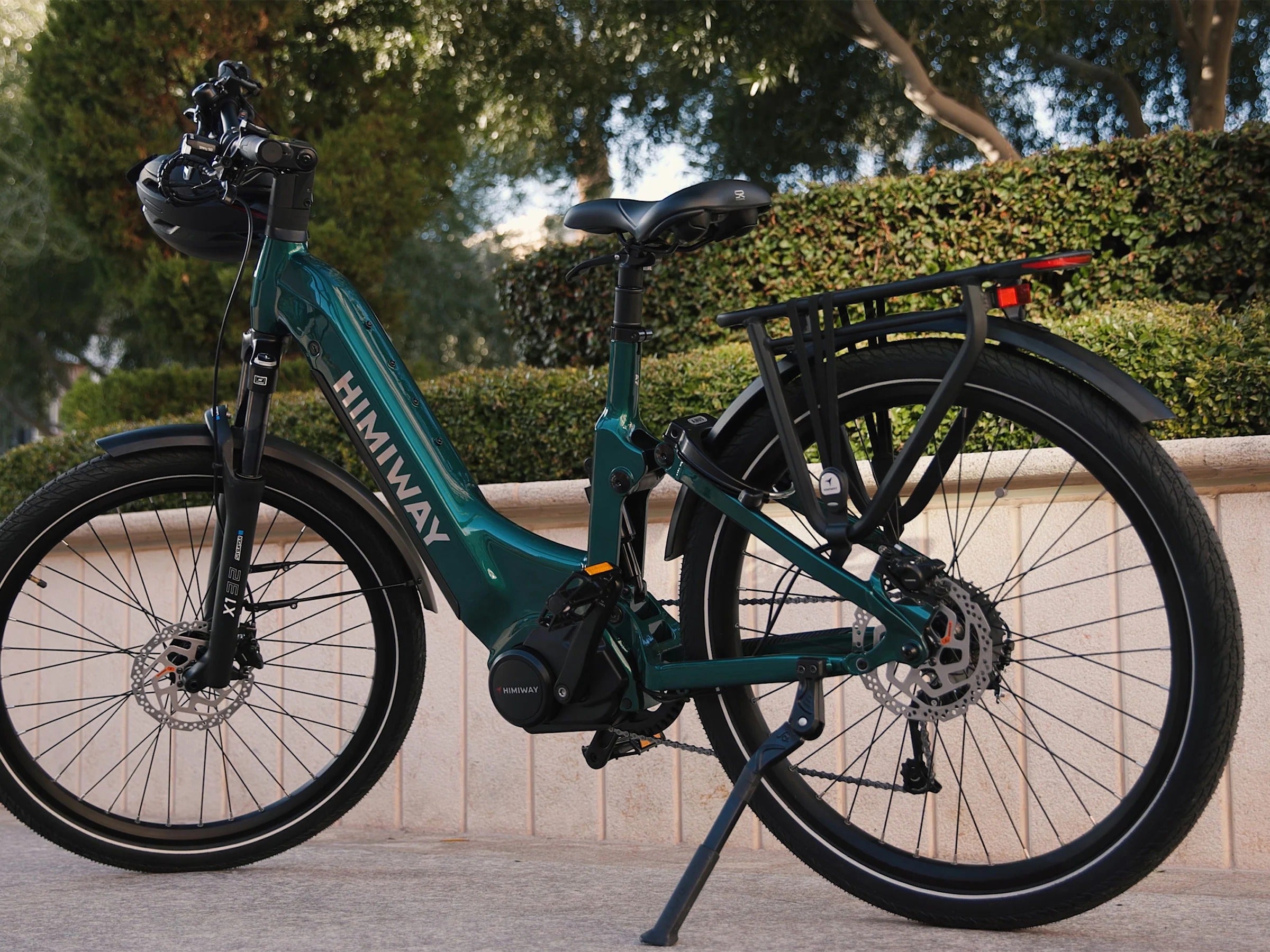 Teal electric bike with 'Himawari' branding parked on a sidewalk.