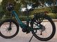 Teal electric bike with 'Himawari' branding parked on a sidewalk.